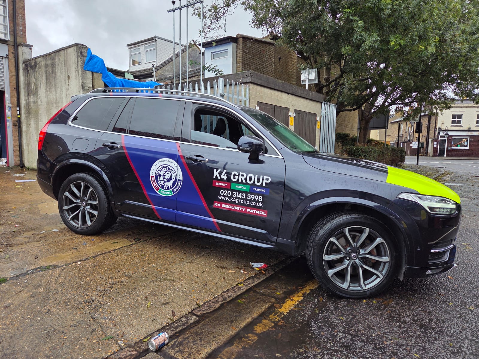 Dark SUV with K4 Group security patrol branding