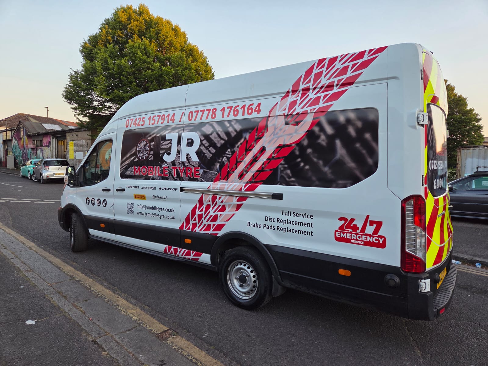 White JR Mobile Tyre van with red tyre-track graphics