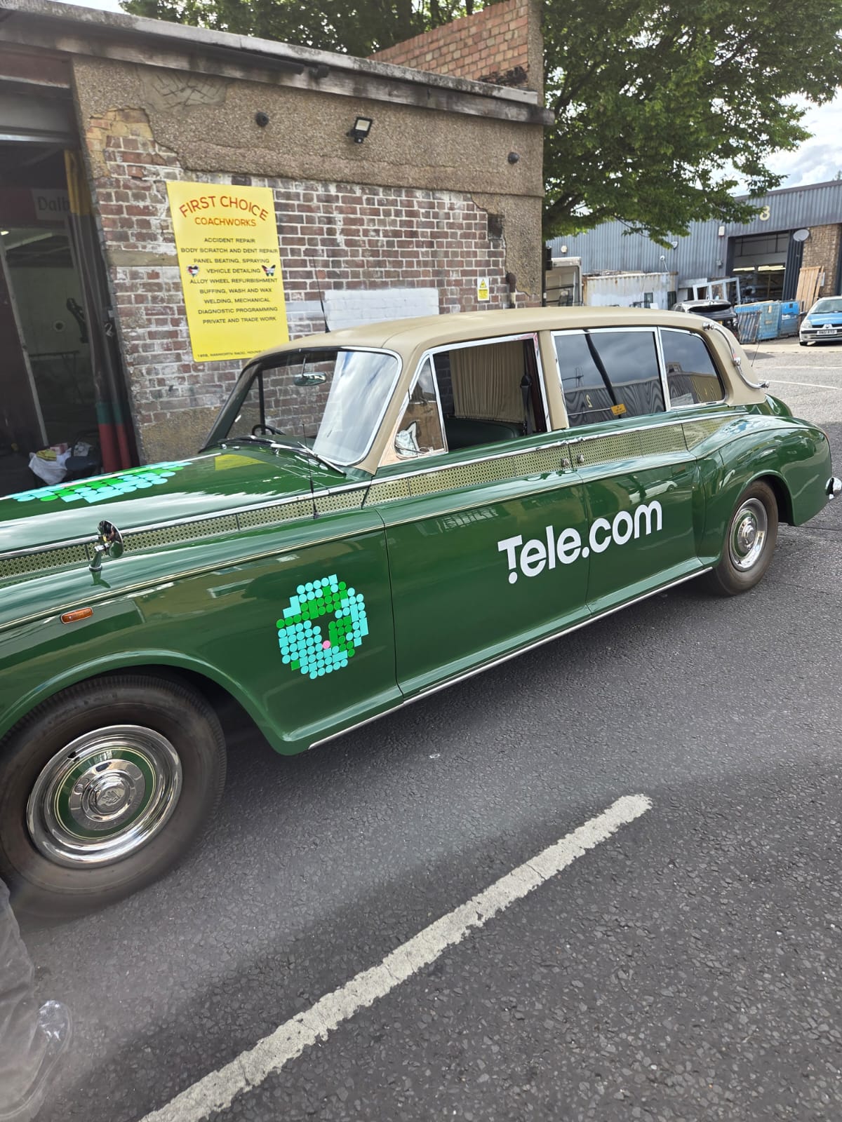 Green classic limousine with Tele.com logo graphics